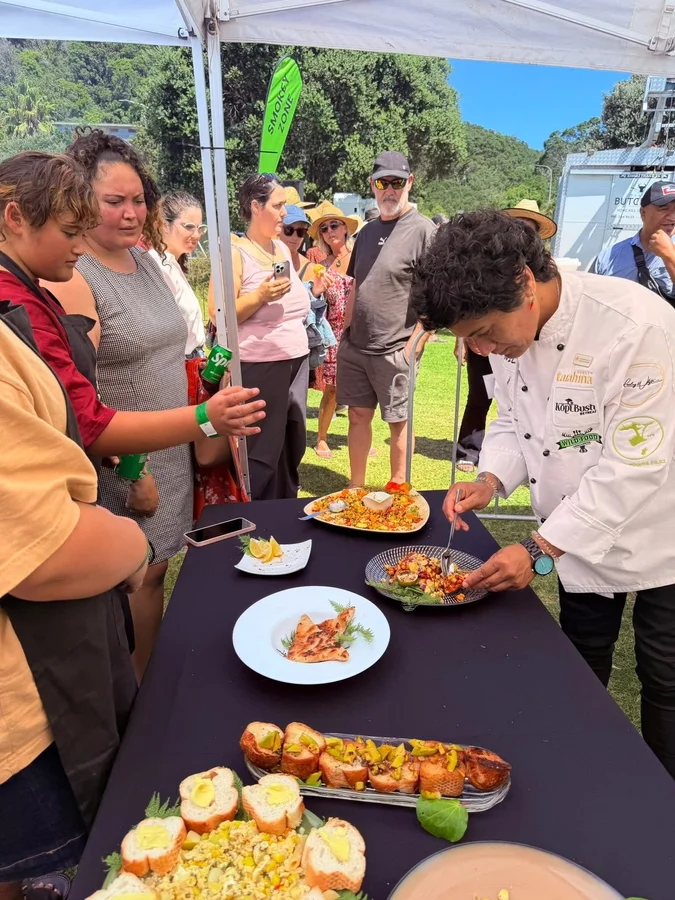 Outdoor food demonstration with an audience